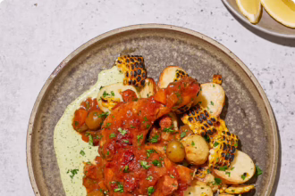 Slow-braised chicken in tomato sugo with aji verde, roasted potatoes, olives and charred corn.