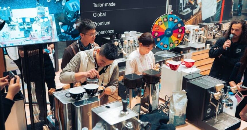 Baristas preparing coffee at espresso machines during a live demonstration at the Melbourne International Coffee Expo.