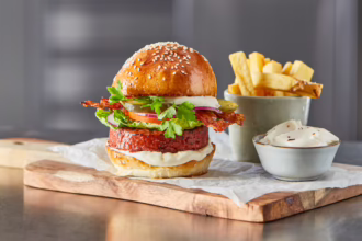 BLT burger with roasted garlic aioli, served with thick-cut chips and extra aioli.
