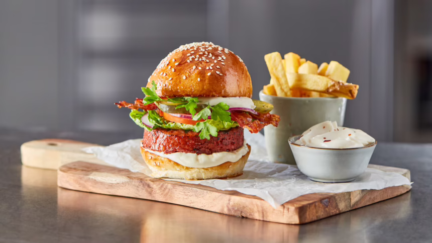 BLT burger with roasted garlic aioli, served with thick-cut chips and extra aioli.