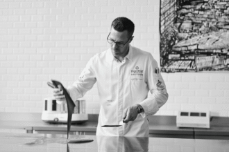 Callebaut Ambassador Ryan Stevenson tempering chocolate on a workbench at the Chocolate Academy.