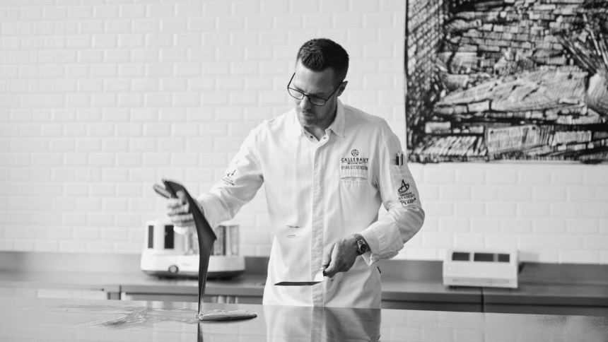 Callebaut Ambassador Ryan Stevenson tempering chocolate on a workbench at the Chocolate Academy.