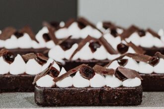Black Forest slices topped with piped cream, cherries and chocolate shards.