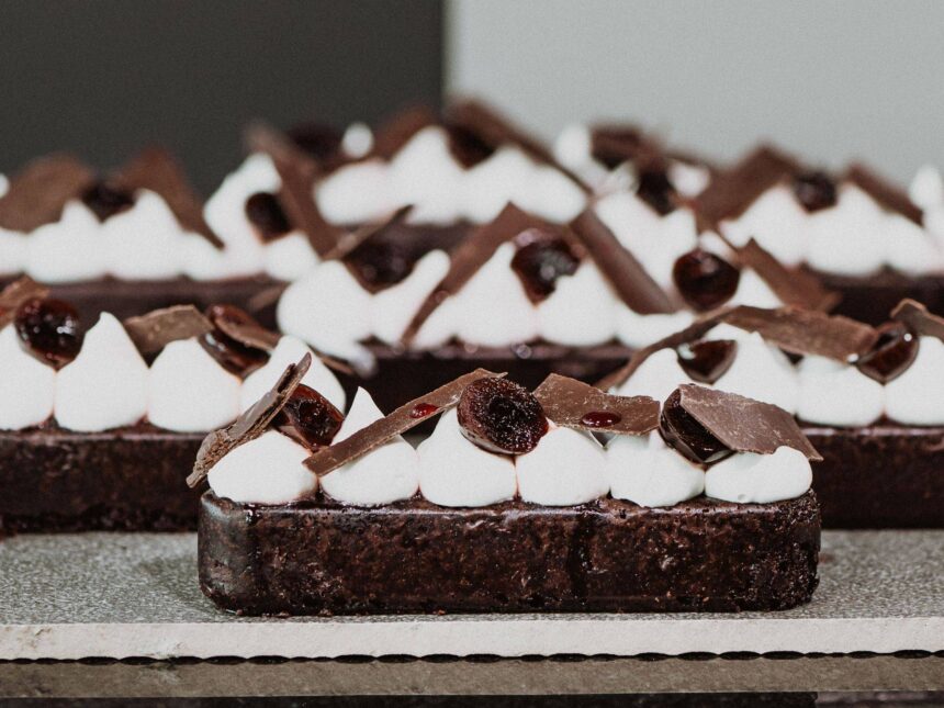 Black Forest slices topped with piped cream, cherries and chocolate shards.