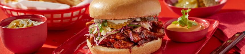 Pulled pork brioche burger topped with grilled pineapple, pickles and fresh slaw.