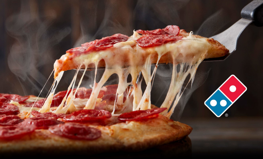 Slice of pepperoni pizza lifted with melted cheese stretching from the remaining pizza, alongside the Domino’s logo.