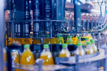 Bottled drinks on a conveyor at a manufacturing warehouse.
