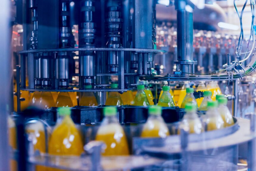 Bottled drinks on a conveyor at a manufacturing warehouse.