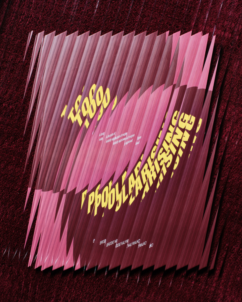 Copies of Brodie Nalywajko’s cookbook Too Polarising arranged in a stack against a dark red background.