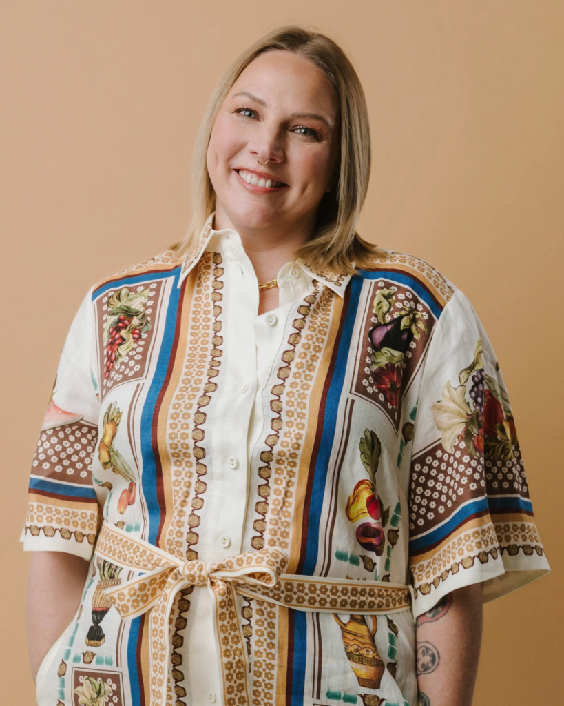 Brodie Nalywajko smiling in a patterned shirt against a warm neutral background.